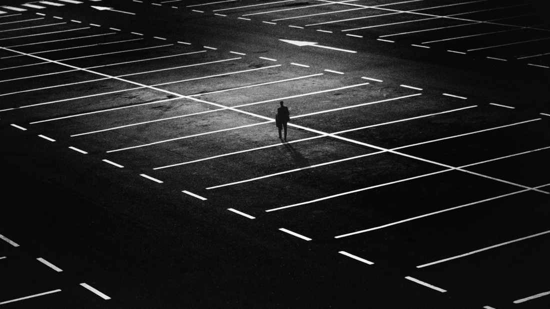 man standing on parking lot